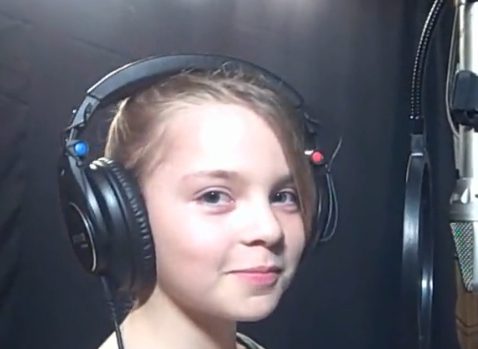Young girl recording with microphone