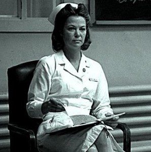 Woman in white nurse outfit, seated
