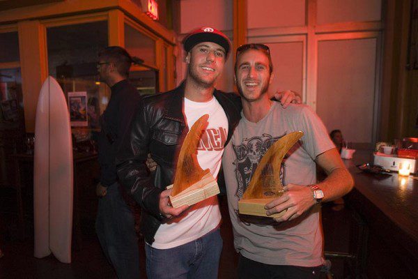 Smiling duo with awards at event