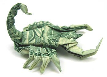 Dollar bill folded into scorpion shape
