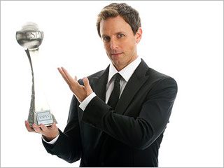 Man holding a trophy in suit