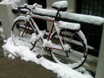Red bike buried in fresh snow
