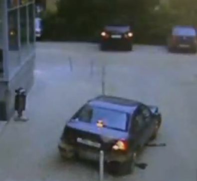 Car stuck on metal pole