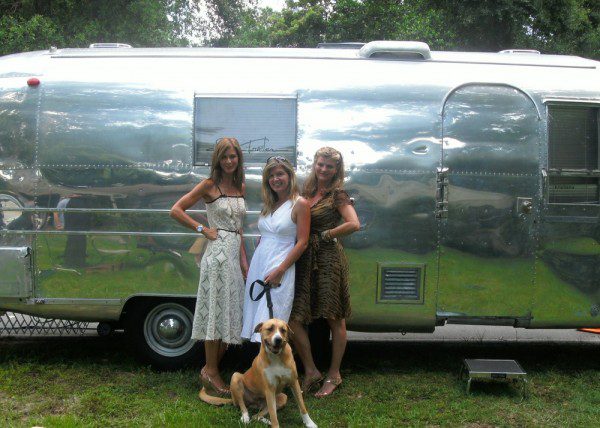 Women and dog in front of camper