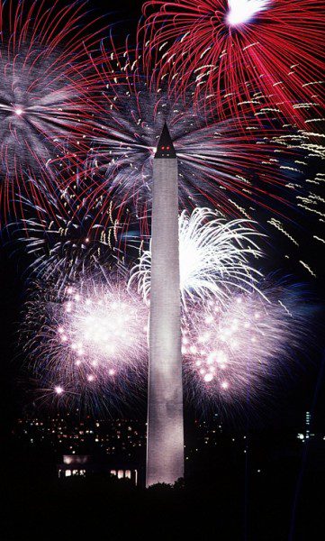 Monument illuminated by colorful fireworks display