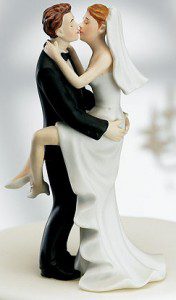 Bride and groom figurine embrace