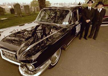Vintage vehicle parked in cemetery setting
