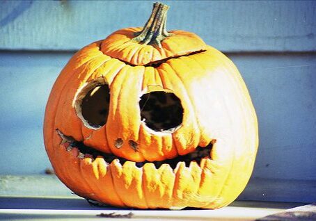Cracked pumpkin with carved face