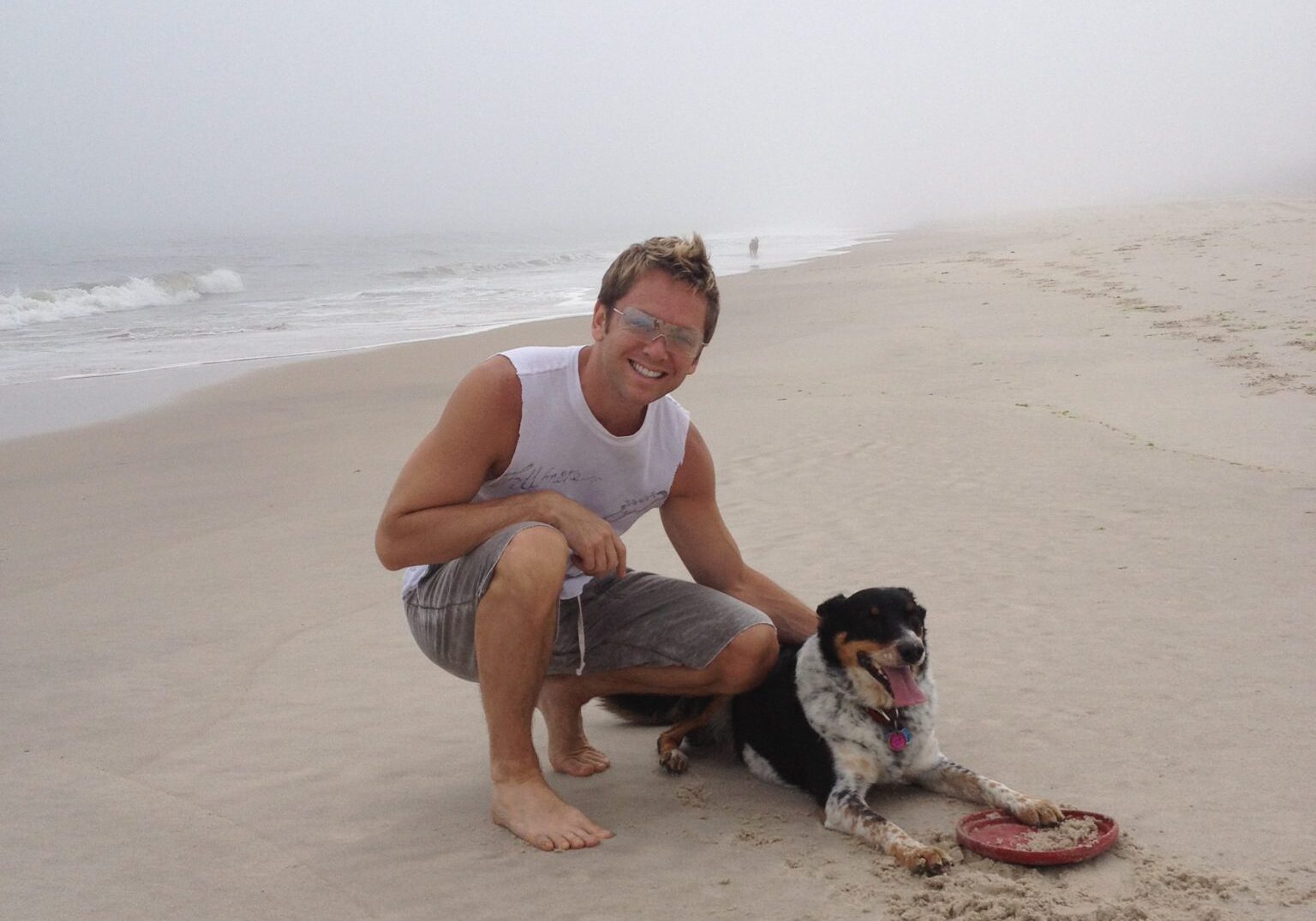 Man and dog playing with frisbee
