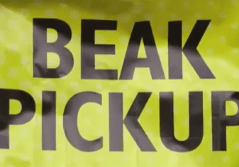Yellow sign with "BEAK PICKUP" text