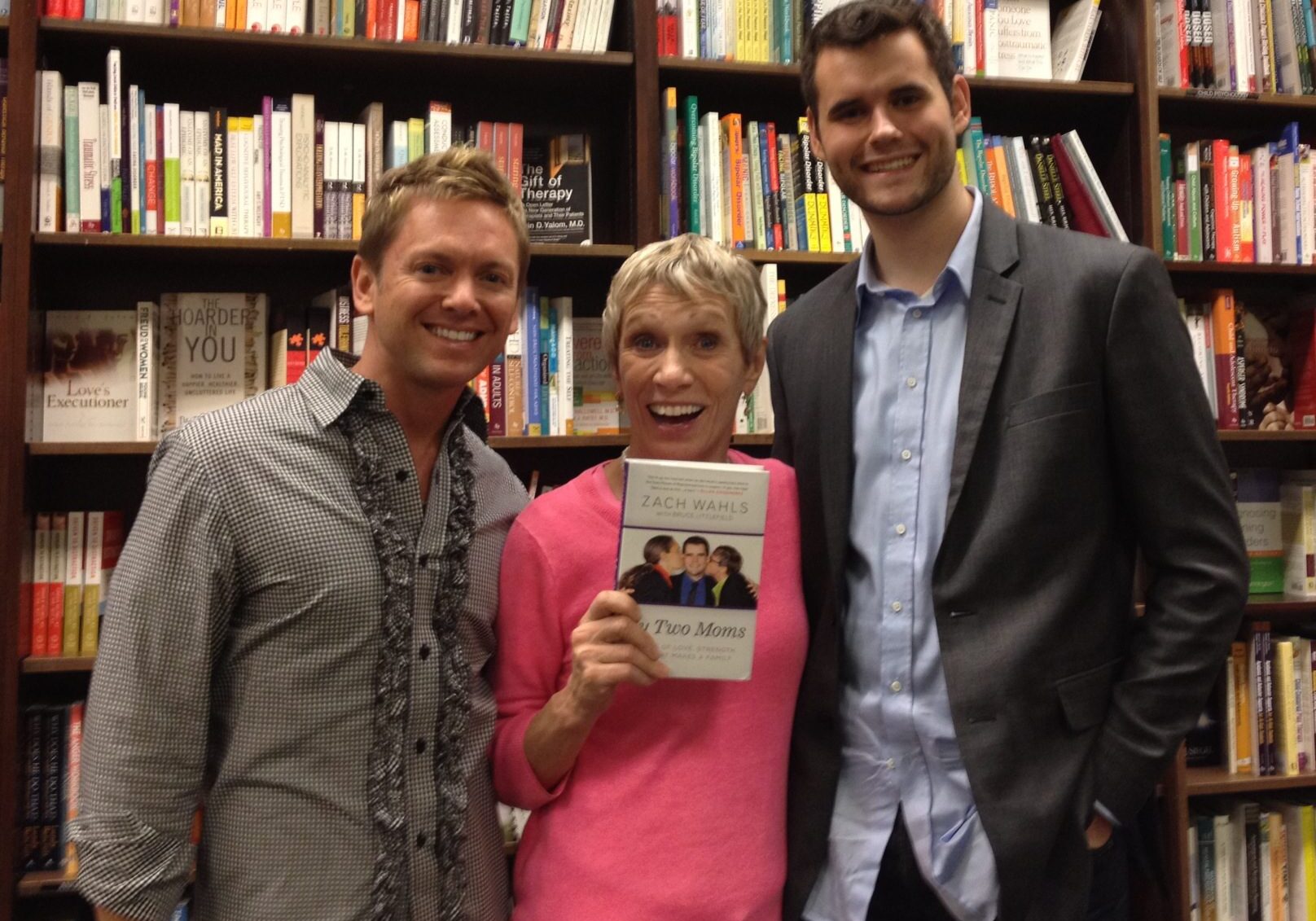 Smiling group in front of bookshelves