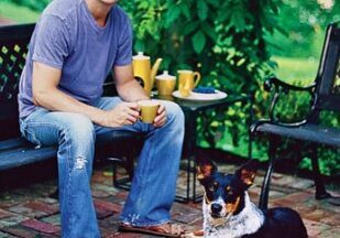 Man sitting with dog on patio