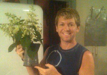 Man holding a vase with flowers