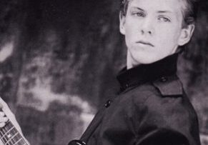 Young musician holding a guitar