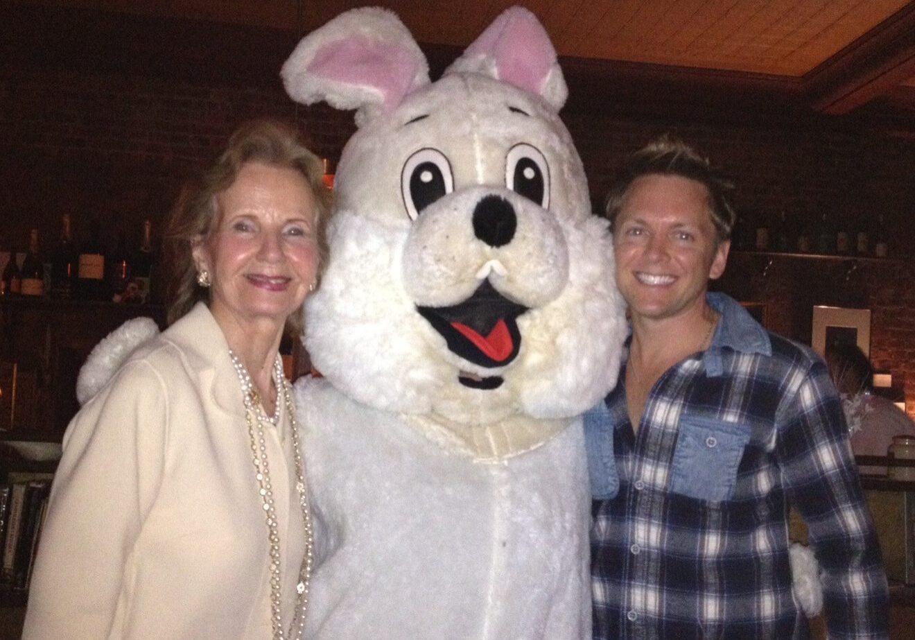 People posing with giant rabbit costume