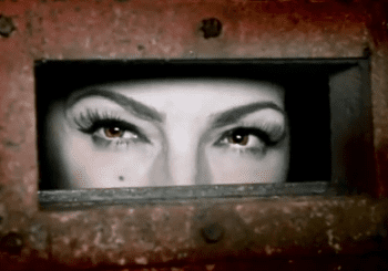 Woman's eyes looking through a slot