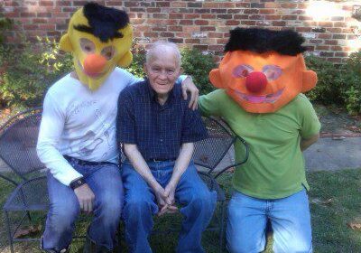 Group posing with colorful character masks.