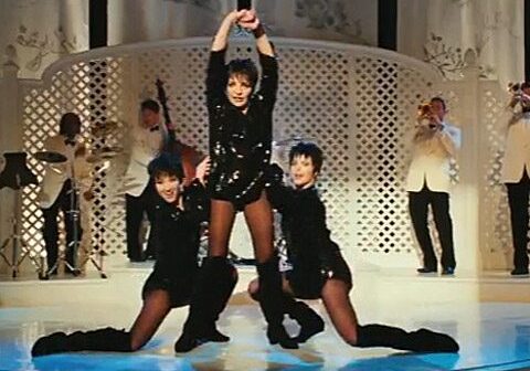Three dancers performing on stage