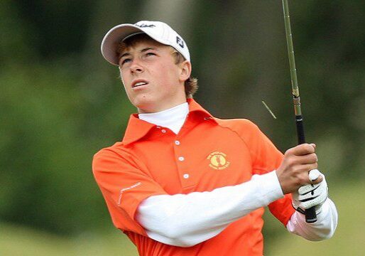 Golfer swinging club on the course