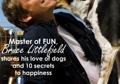 Man laughing with a dog outdoors