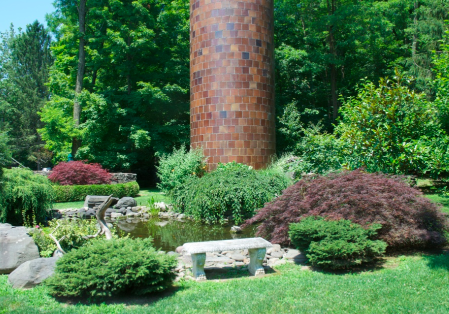Tall tower surrounded by vibrant garden.