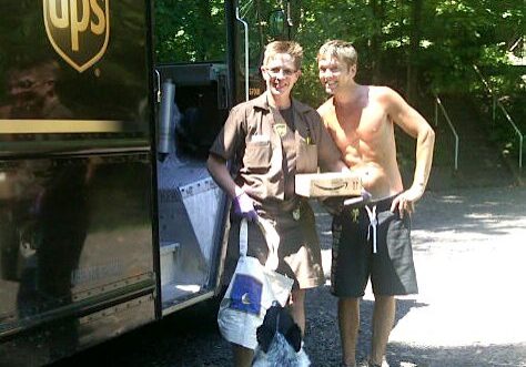Man receiving package from UPS driver