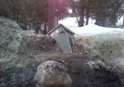 Trash bin buried in snow