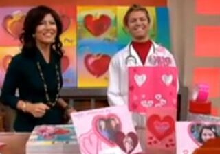 Smiling duo presenting colorful heart crafts