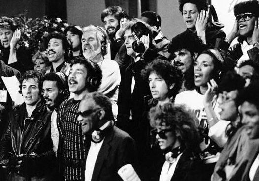 Singers wearing headphones in recording session