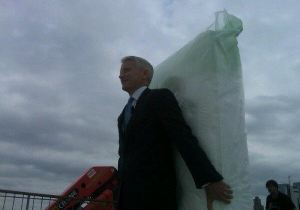 Individual in formal wear with big package