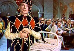 Medieval jester with basket indoors