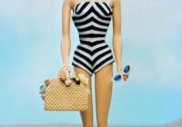 Doll holding sunglasses and handbag