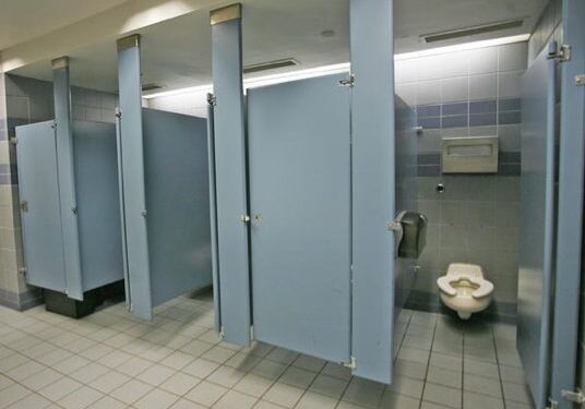 Clean bathroom stalls with tiled flooring