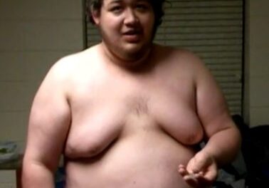 Man with curly hair, shirtless, indoors