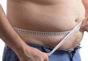 Man checking waist size with tape