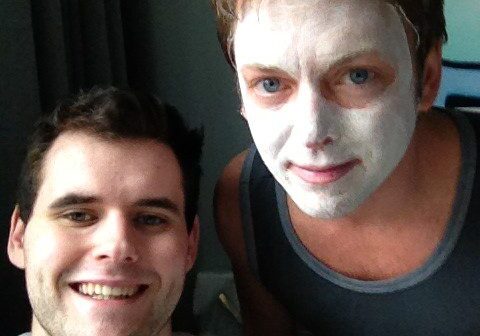 Two friends, one with a face mask