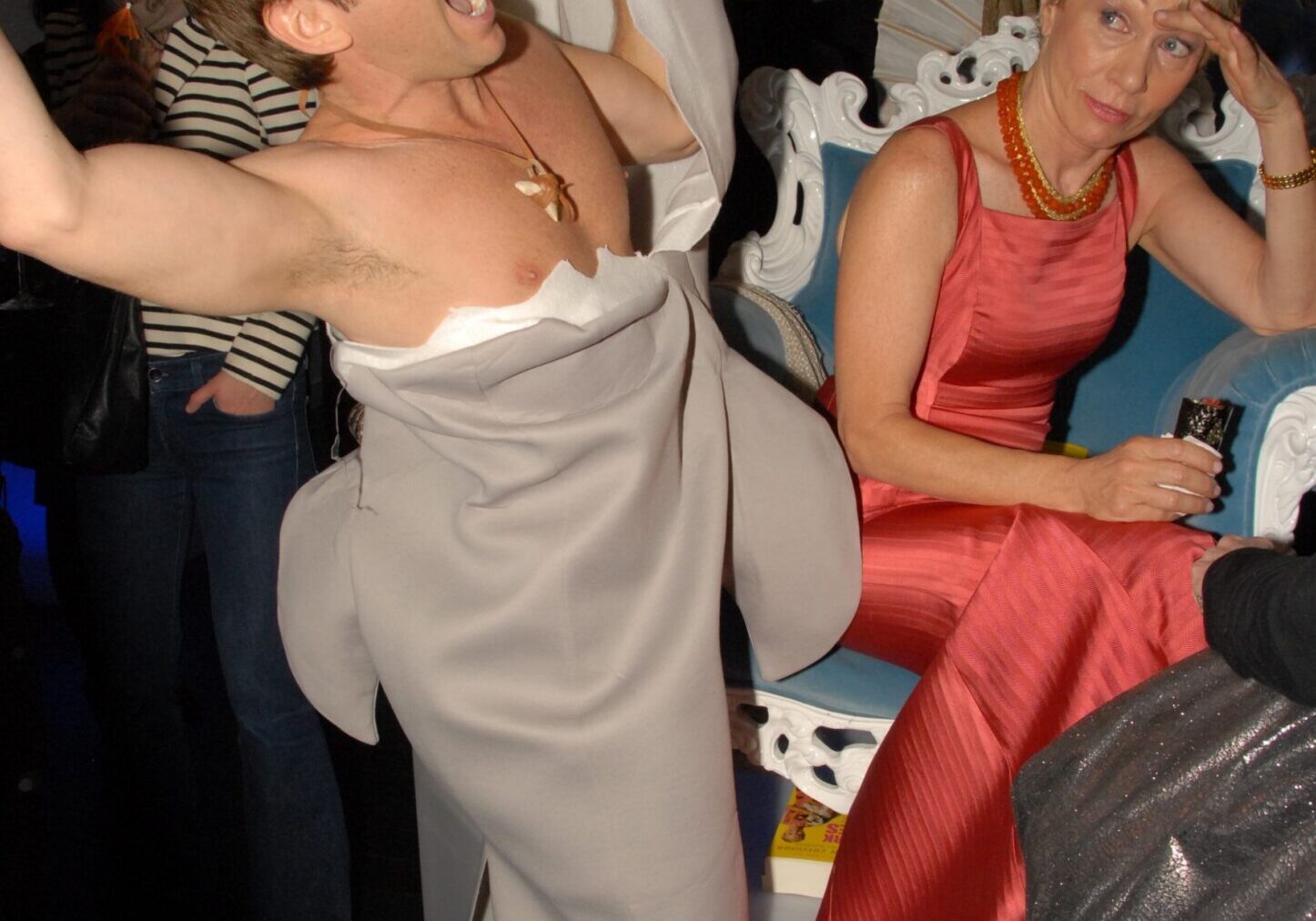 Man in shark costume, woman in red dress
