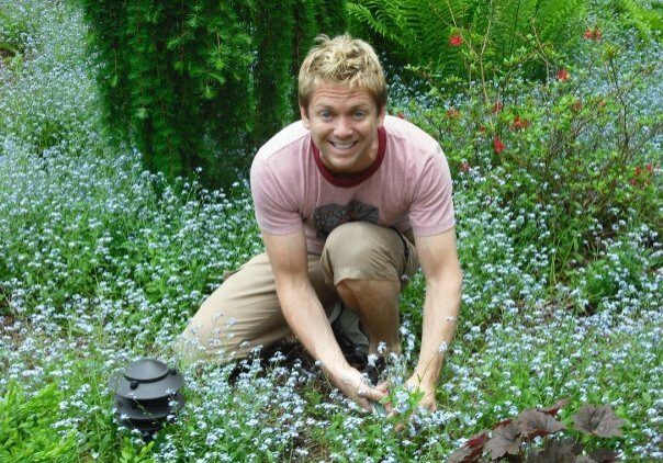 Person tending plants in a garden
