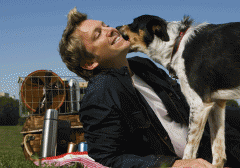 Dog licking man's face outdoors