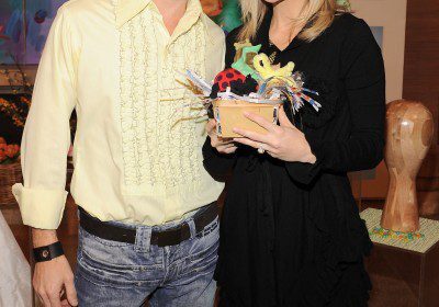Man with bunny ears and woman smiling