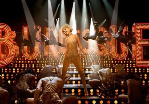Glamorous showgirl on stage with lights