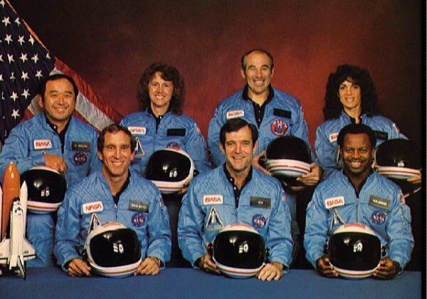 Astronauts in blue NASA uniforms