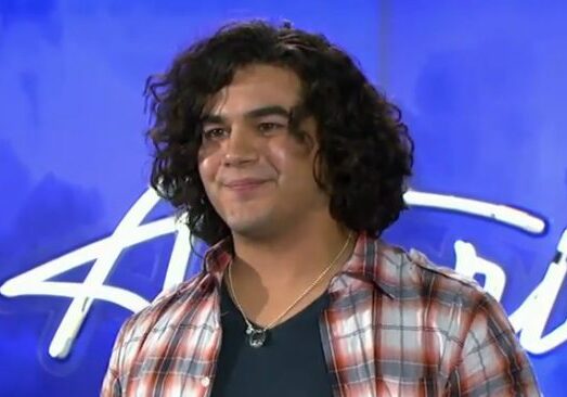 Person with curly hair on stage