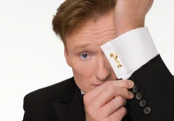 Person wearing black suit with cufflinks