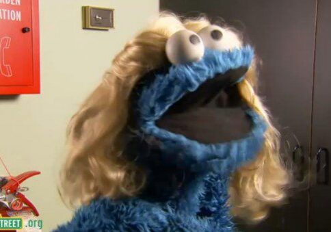 Blue puppet with blonde wig