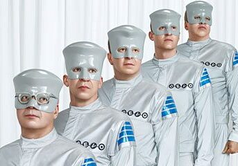 Band members in silver futuristic attire