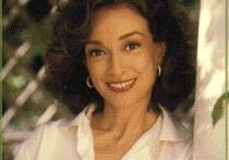 Actress smiling in white blouse