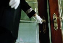 Gloved hand opening a glass door