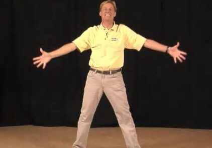 Cheerful man in casual attire, black background