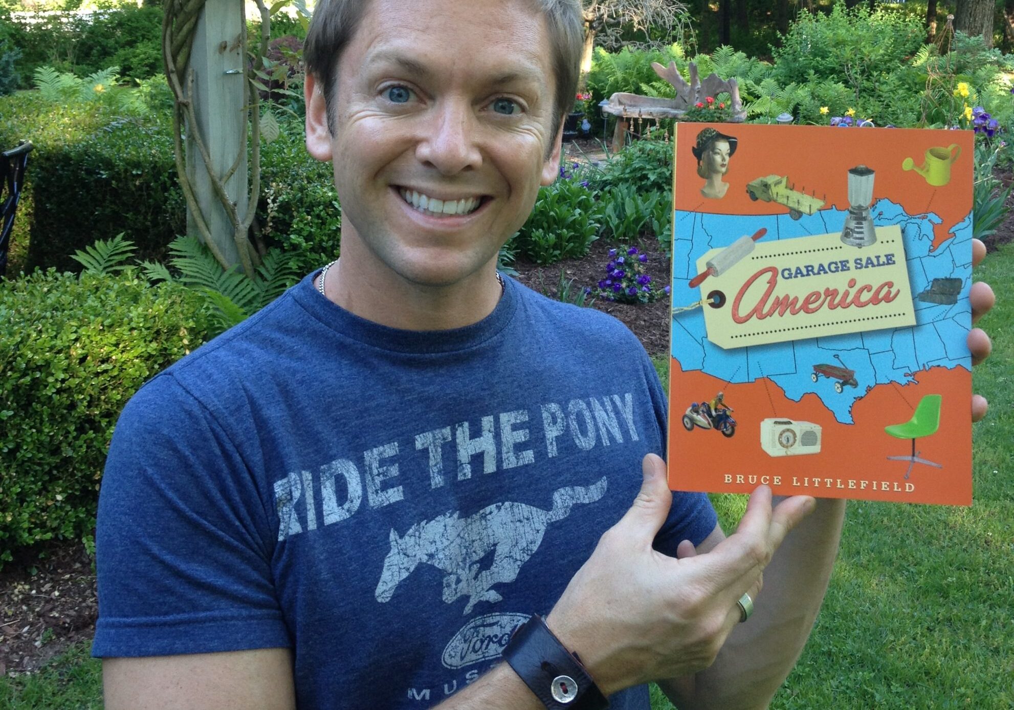 Man holding a book outdoors